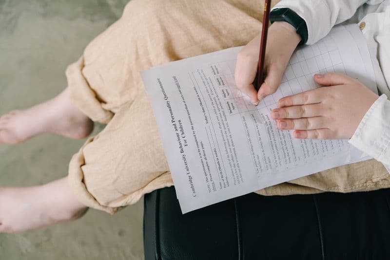 Child focused on writing during a test