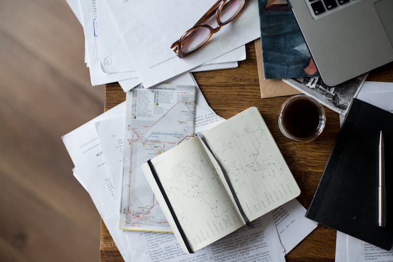 Desk with maps, laptop and planning notes