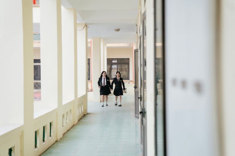 Students walking through a bright school corridor