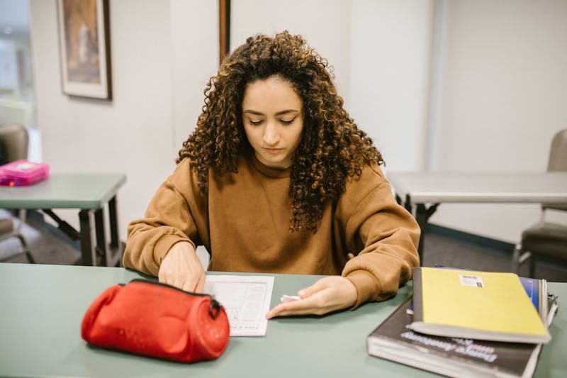 Student revising for an exam with books and notes